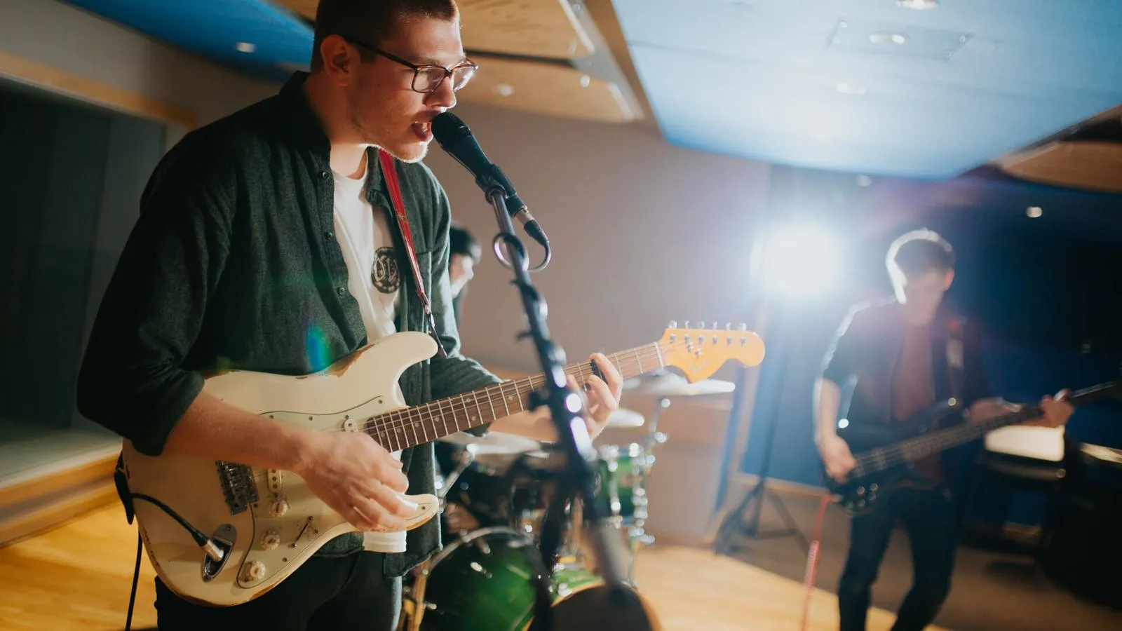 A band rehearsing in a music studio
