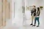 Two students stand in an art gallery