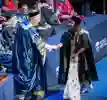 A student shaking hands with the chancellor on the graduation stage.