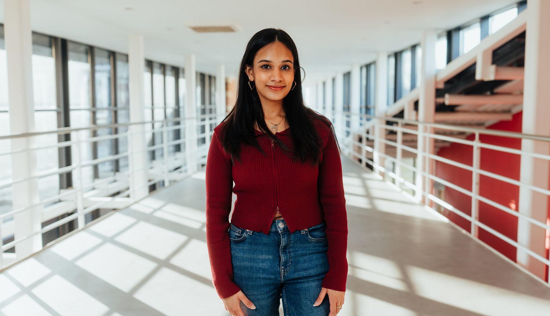 Student posing on balcony in business building