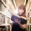 Student reading a book in library racks