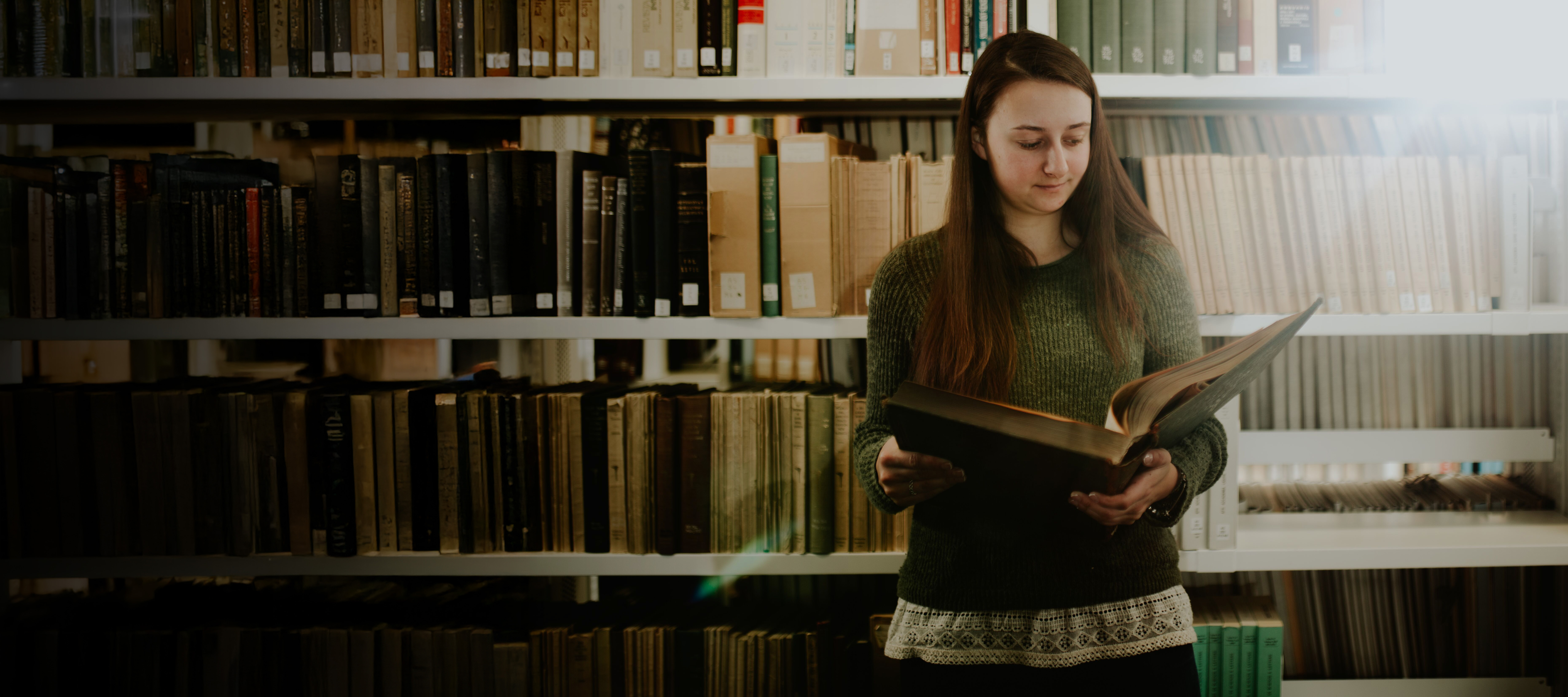 History Student reading a book in the library