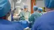 surgeons in scrubs carrying out an operation