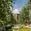 Some of the blocks of Westfield Court seen through gaps in the trees and foliage planted between them.