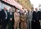 group of ten people standing by a canopy in front of the Houses of Parliament