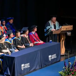 Graduation ceremony taking place with an honorary graduate on stage